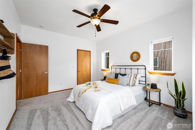 bedroom with ceiling fan, baseboards, and carpet flooring