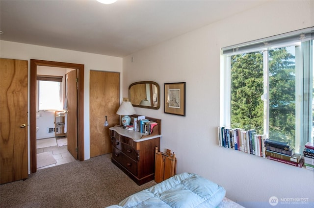 carpeted bedroom featuring connected bathroom