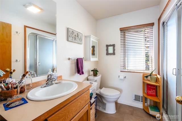 bathroom with vanity, visible vents, a shower stall, tile patterned floors, and toilet