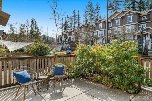 view of patio / terrace featuring a residential view and fence