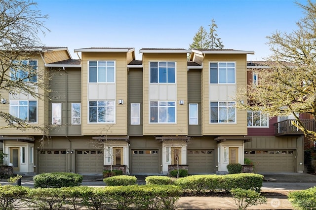 multi unit property featuring a garage and stucco siding