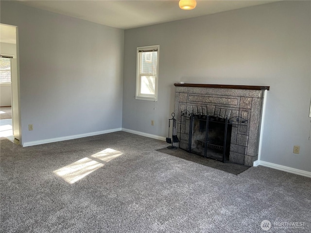 unfurnished living room featuring carpet floors, a fireplace, and baseboards