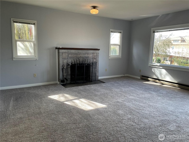 unfurnished living room with a baseboard radiator, carpet, baseboards, and a fireplace with flush hearth