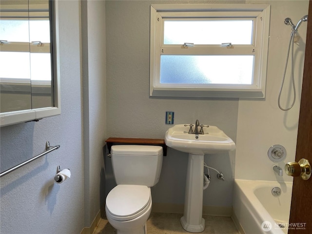 full bath with toilet, shower / tub combination, and baseboards