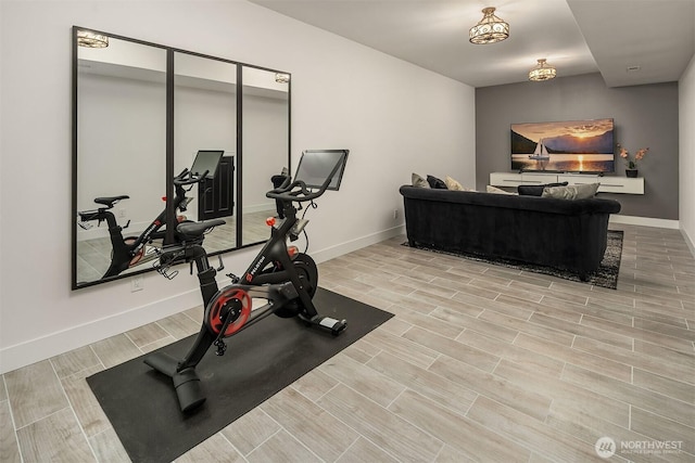 exercise room featuring wood finish floors and baseboards