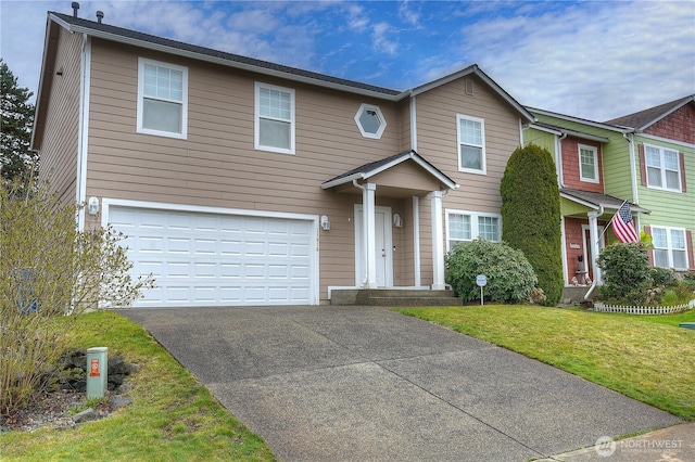 view of front of home with a front yard, driveway, and a garage