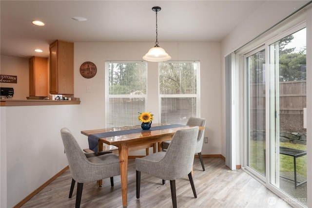 dining area featuring light wood finished floors, baseboards, and recessed lighting
