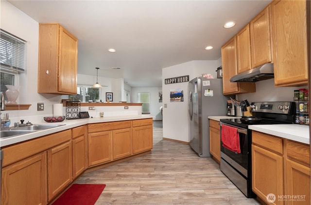 kitchen featuring light countertops, stainless steel appliances, under cabinet range hood, light wood-style floors, and a peninsula