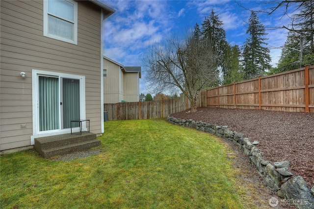 view of yard with a fenced backyard
