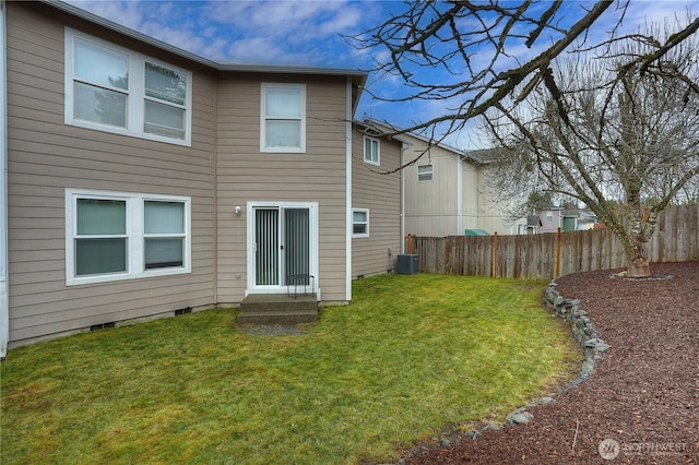 back of house with a lawn, fence, central AC, and entry steps