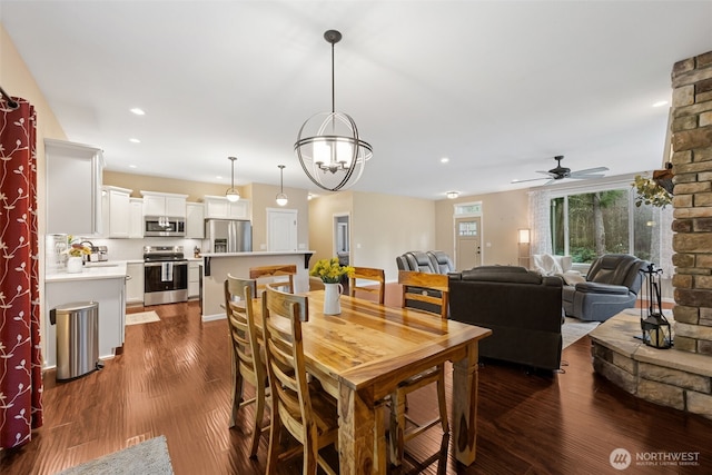 dining area featuring a ceiling fan, recessed lighting, and dark wood-style flooring