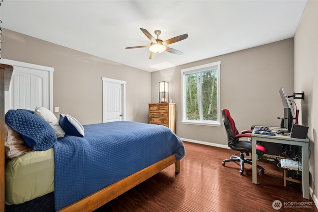 bedroom featuring a ceiling fan, baseboards, and wood finished floors