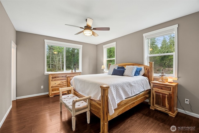 bedroom featuring ceiling fan, dark wood finished floors, and baseboards