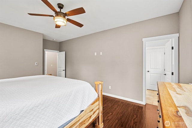 bedroom featuring a ceiling fan, baseboards, and wood finished floors