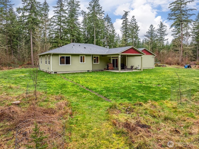 back of property featuring a patio area and a lawn