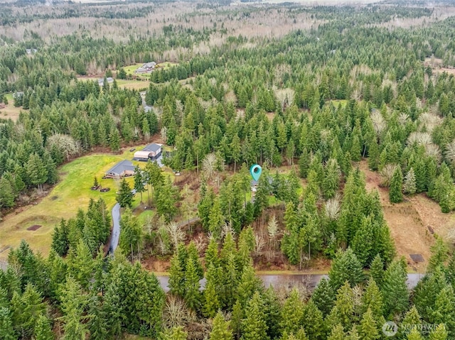 drone / aerial view featuring a wooded view