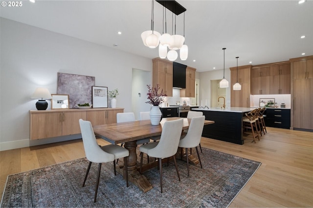 dining room featuring baseboards, recessed lighting, and light wood-style floors