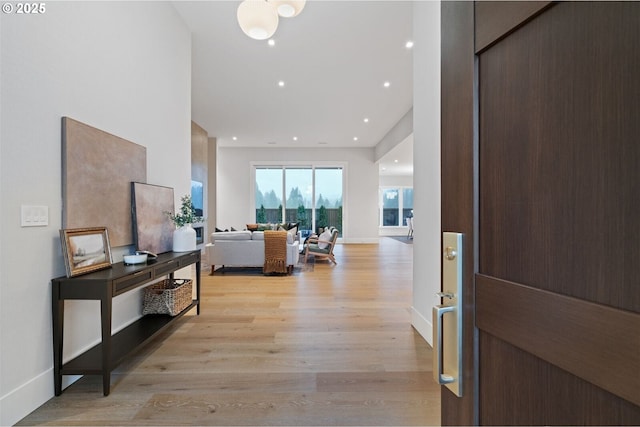 foyer featuring recessed lighting, light wood-style flooring, and baseboards