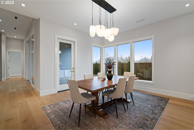 dining space featuring a chandelier, recessed lighting, baseboards, and light wood-style floors