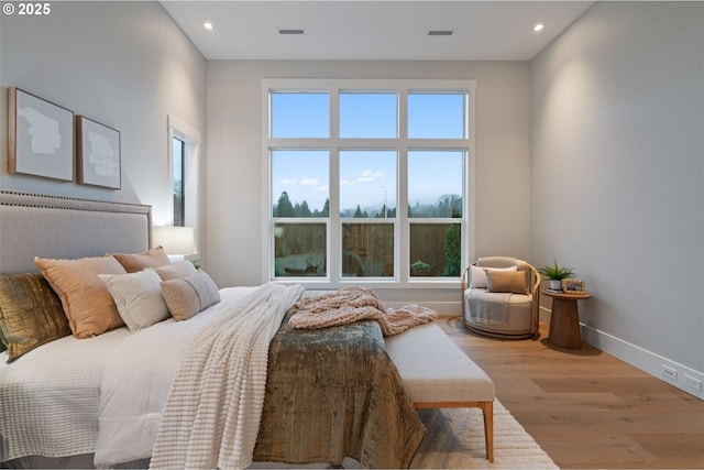 bedroom featuring recessed lighting, wood finished floors, visible vents, and baseboards