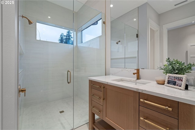 full bath with a shower stall and vanity