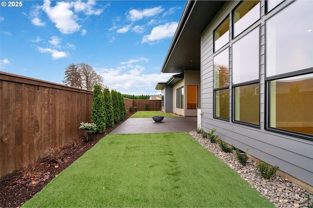 view of yard with a patio area and a fenced backyard