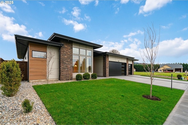 view of front of property featuring driveway, stone siding, an attached garage, and a front lawn