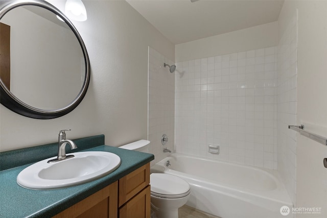 bathroom featuring toilet, vanity, and shower / bathing tub combination