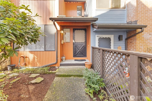 doorway to property featuring brick siding