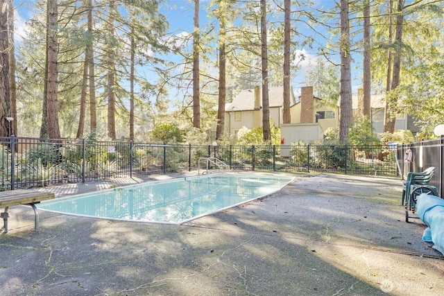 community pool featuring a patio area and fence