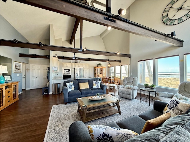 living area with beamed ceiling, baseboards, high vaulted ceiling, and dark wood finished floors