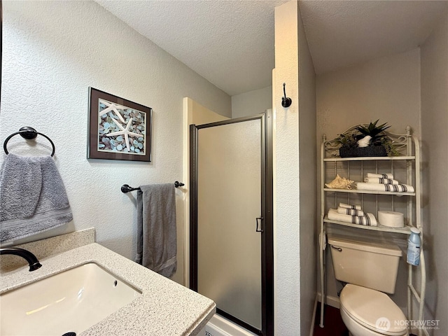 full bath featuring toilet, a textured wall, a stall shower, and a textured ceiling