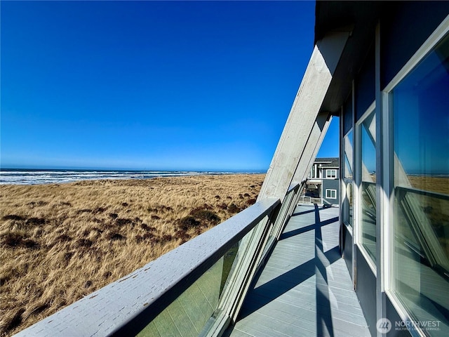 exterior space with a water view and a beach view