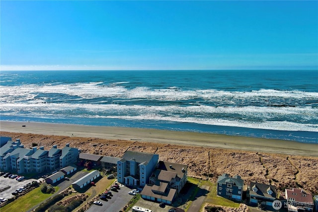 drone / aerial view with a water view and a view of the beach