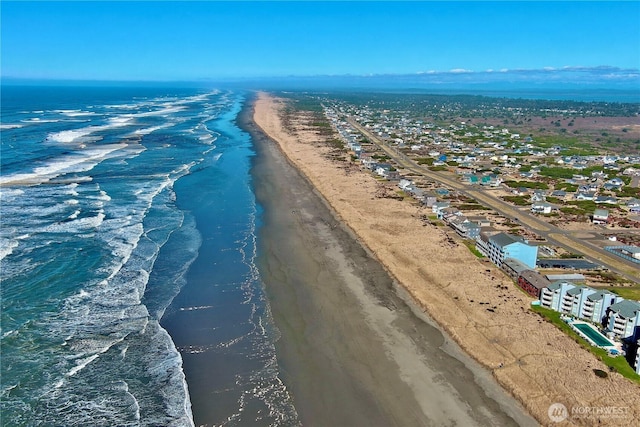 aerial view featuring a water view and a beach view