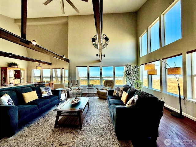 living room featuring ceiling fan, baseboards, and wood finished floors