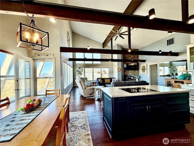 kitchen with visible vents, beamed ceiling, light countertops, dark wood-style floors, and black electric cooktop