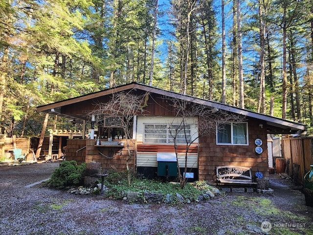 view of side of home featuring fence