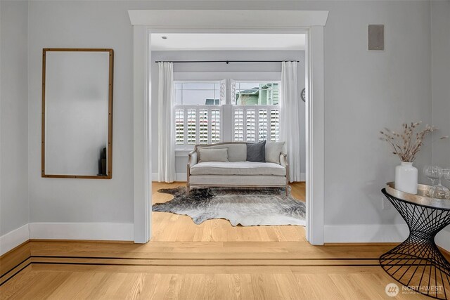 living area with wood finished floors and baseboards