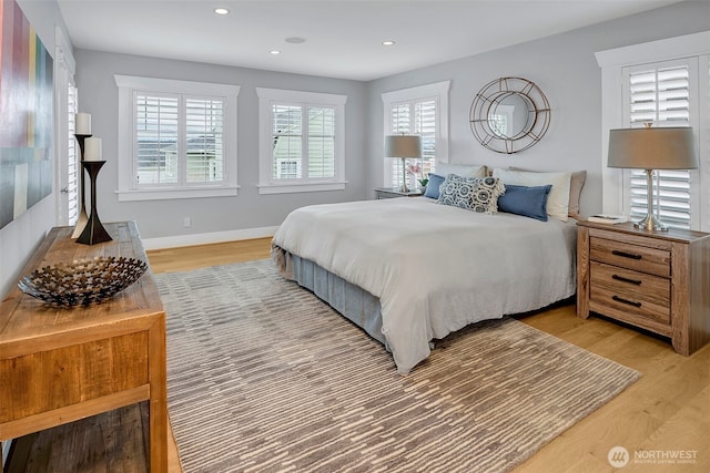 bedroom with recessed lighting, baseboards, and light wood finished floors