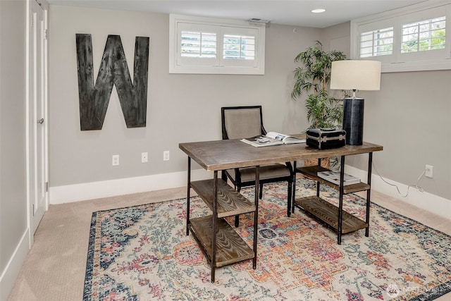 carpeted home office with a healthy amount of sunlight and baseboards