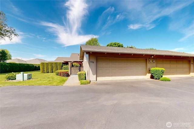 garage with a gate and fence