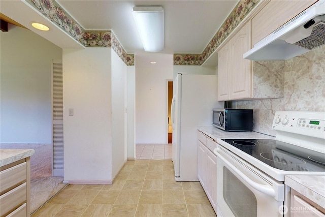 kitchen featuring electric stove, light countertops, stainless steel microwave, backsplash, and under cabinet range hood