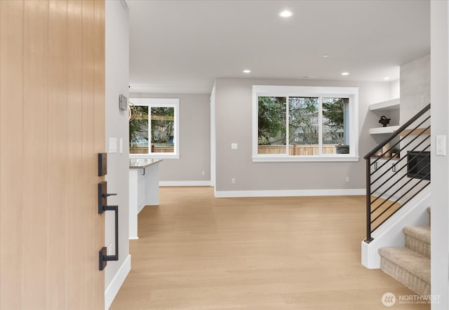 foyer entrance featuring light wood-type flooring, stairs, baseboards, and recessed lighting