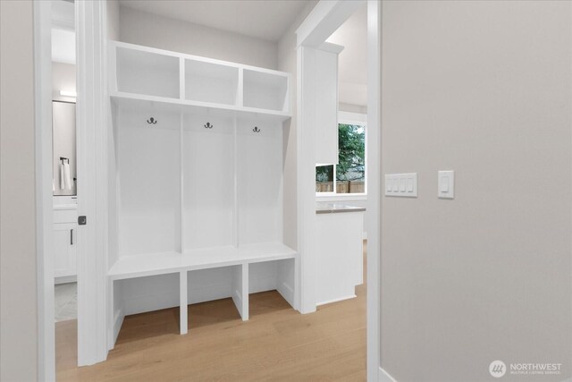 mudroom featuring light wood-type flooring and baseboards