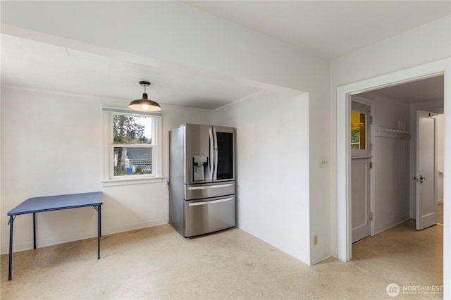 kitchen with stainless steel fridge and baseboards