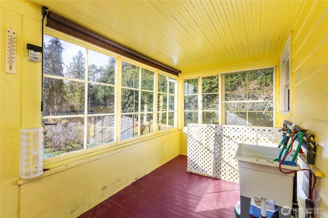 sunroom / solarium featuring wood ceiling and a wealth of natural light