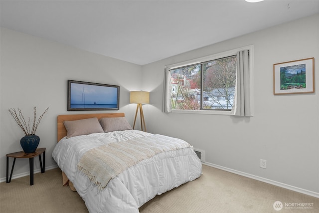 carpeted bedroom with visible vents and baseboards