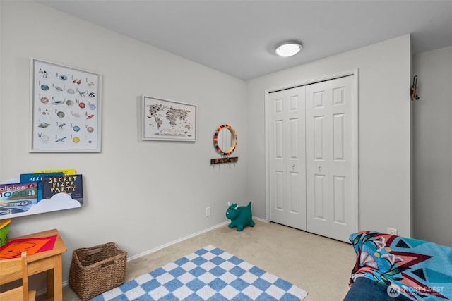 recreation room featuring baseboards and carpet flooring