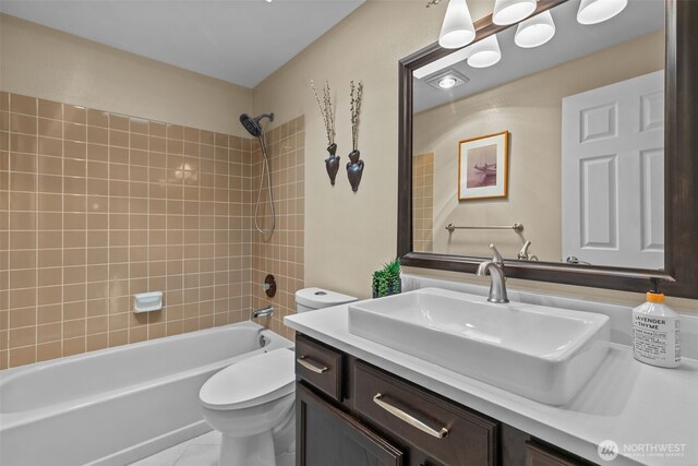 full bathroom featuring toilet, tile patterned floors, bathtub / shower combination, and vanity